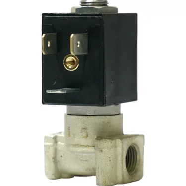 A close-up of a Bezzera 7701123.01 2-Way Solenoid Valve shows its black rectangular coil, metallic connectors, and silver metal base with pipe threading. © 2025 1st-line.com