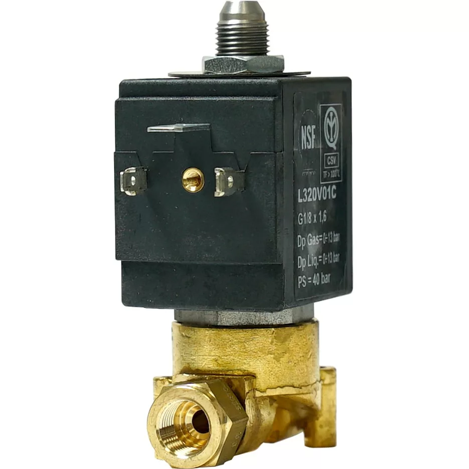 A close-up of the Bezzera 7702416R 3-Way Solenoid Valve for espresso machines, featuring a black rectangular coil, metal screw terminals, and a gold-toned brass body with threaded pipe connections. © 2025 1st-line.com