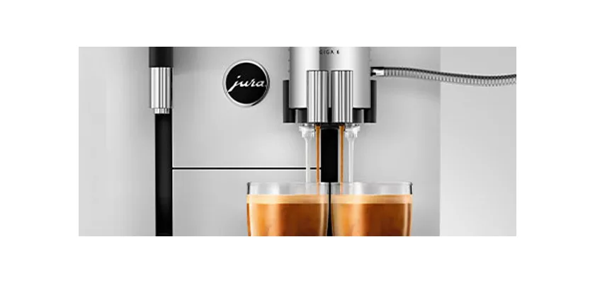 A close-up of the DISCONTINUED Jura GIGA 6 (NAA) Automatic Espresso Machine pouring two espresso shots into clear glass cups. © 2025 1st-line.com
