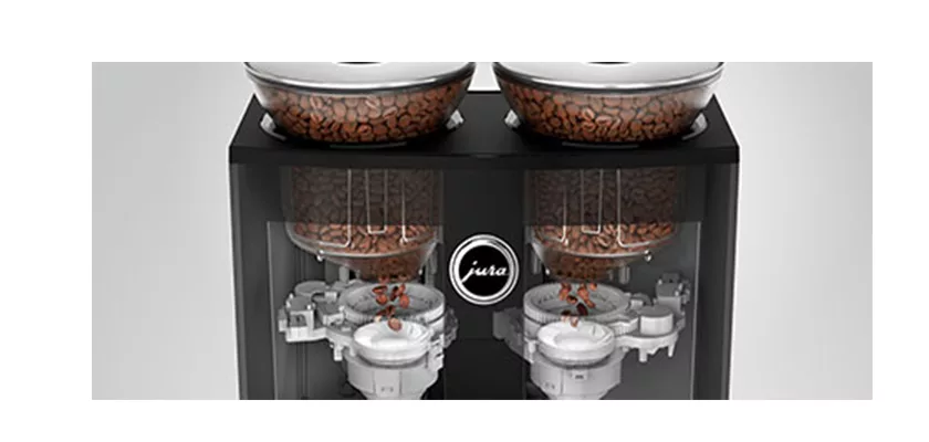 Close-up of the DISCONTINUED Jura GIGA 6 (NAA) Automatic Espresso Machine featuring dual transparent bean hoppers, visible internal grinding mechanisms, and the Jura logo centered on the machine. © 2025 1st-line.com