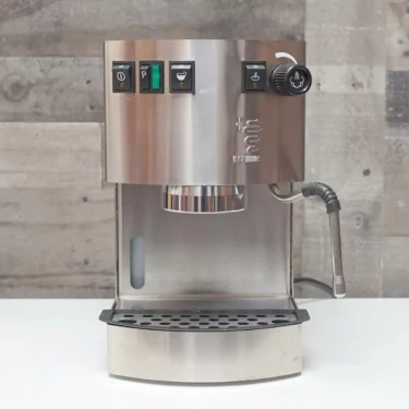 The SIDEWALK SALE - Bezzera New Hobby PM Espresso Machine (E214) features black buttons, a right-side steam wand, and a drip tray below—an ideal addition for any sidewalk sale display. © 2025 1st-line.com