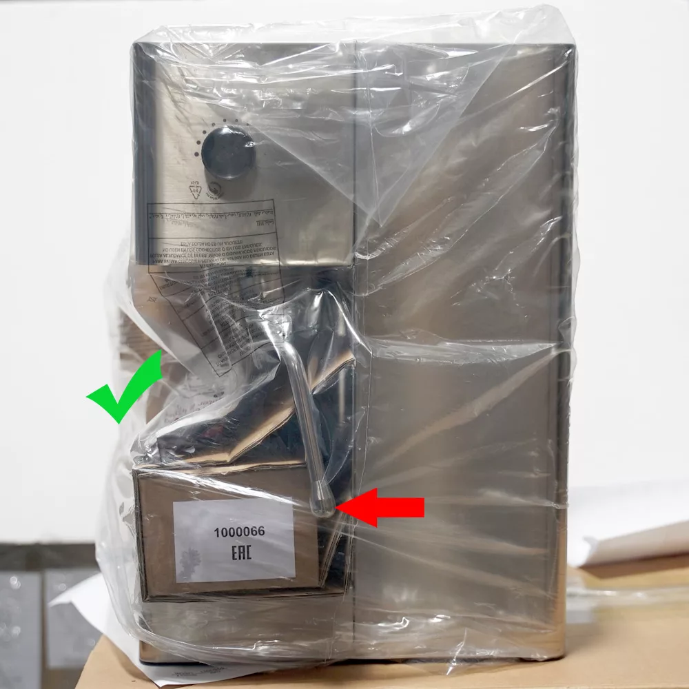 A stainless steel Lelit Elizabeth appliance wrapped in packaging sits on a table. A green check mark points to the top section, while a red arrow highlights a lower compartment labeled 1000066 EAT. © 2025 1st-line.com