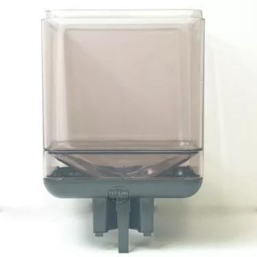 The Faema MFI108 GREY HOPPER is a square, translucent grey plastic container with a black base, dispensing spout, and 1st-Line Equipment label on the front, compatible with select Faema machines. © 2025 1st-line.com