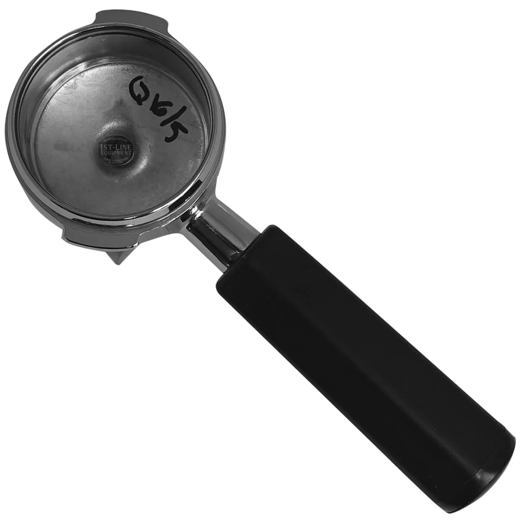 The Pavoni P1-P3-P6 2 Coffees FILTERHOLDER, featuring a metal build and black handle, is shown from above with handwritten markings inside the basket. Suitable for making 2 coffees, it’s set against a plain white background. © 2025 1st-line.com