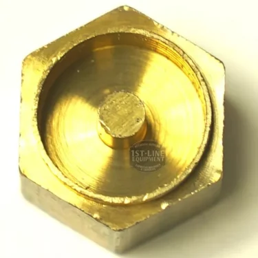 A close-up of the CA.221 GASKET HOLDER, a brass hexagonal screw cap with a raised circular center and shiny metallic finish, shown on a light background. © 2025 1st-line.com