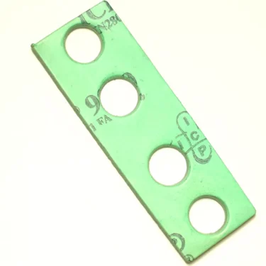 A green rectangular metal plate with four large circular holes in a row, likely designed for F...69 SEEGER RING 16mm fittings, featuring faded black markings and letters on its surface. © 2025 1st-line.com