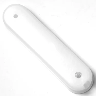 A white, elongated plastic shoehorn with rounded edges and a small hole at one end lies on a white surface next to an F.1359 LEVEL GLASS TANK. © 2025 1st-line.com
