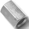 Close-up of the SM.389 HOT WATER PIPE NUT, a silver hexagonal fitting with a hollow center, shown lying on its side on a white background. Its surface has slight texture and minor scratches. © 2025 1st-line.com