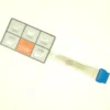 The F.1800 PUSH BUTTON COVER MEMBRANE is a rectangular keypad with six buttons—five featuring cup icons and one orange STOP—plus a flat ribbon cable with a blue connector. © 2025 1st-line.com
