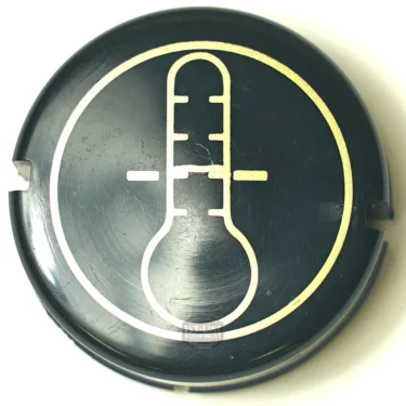 The SP.174 INLET HANDLE LID is a black, circular cap featuring a white thermometer icon with a vertical line and two horizontal marks at the center, signifying temperature measurement or control. © 2025 1st-line.com