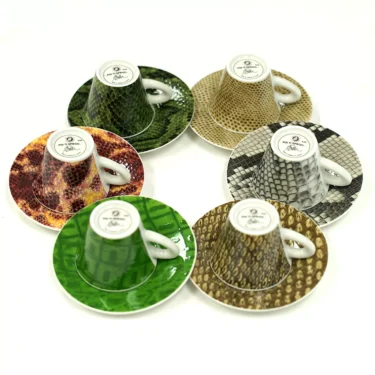 The Francis!Francis! Reptilia Espresso Cups - Set of Six features six espresso cups with matching saucers, each displaying a unique snake-skin pattern in green, brown, tan, orange, or gray on a white background. © 2025 1st-line.com