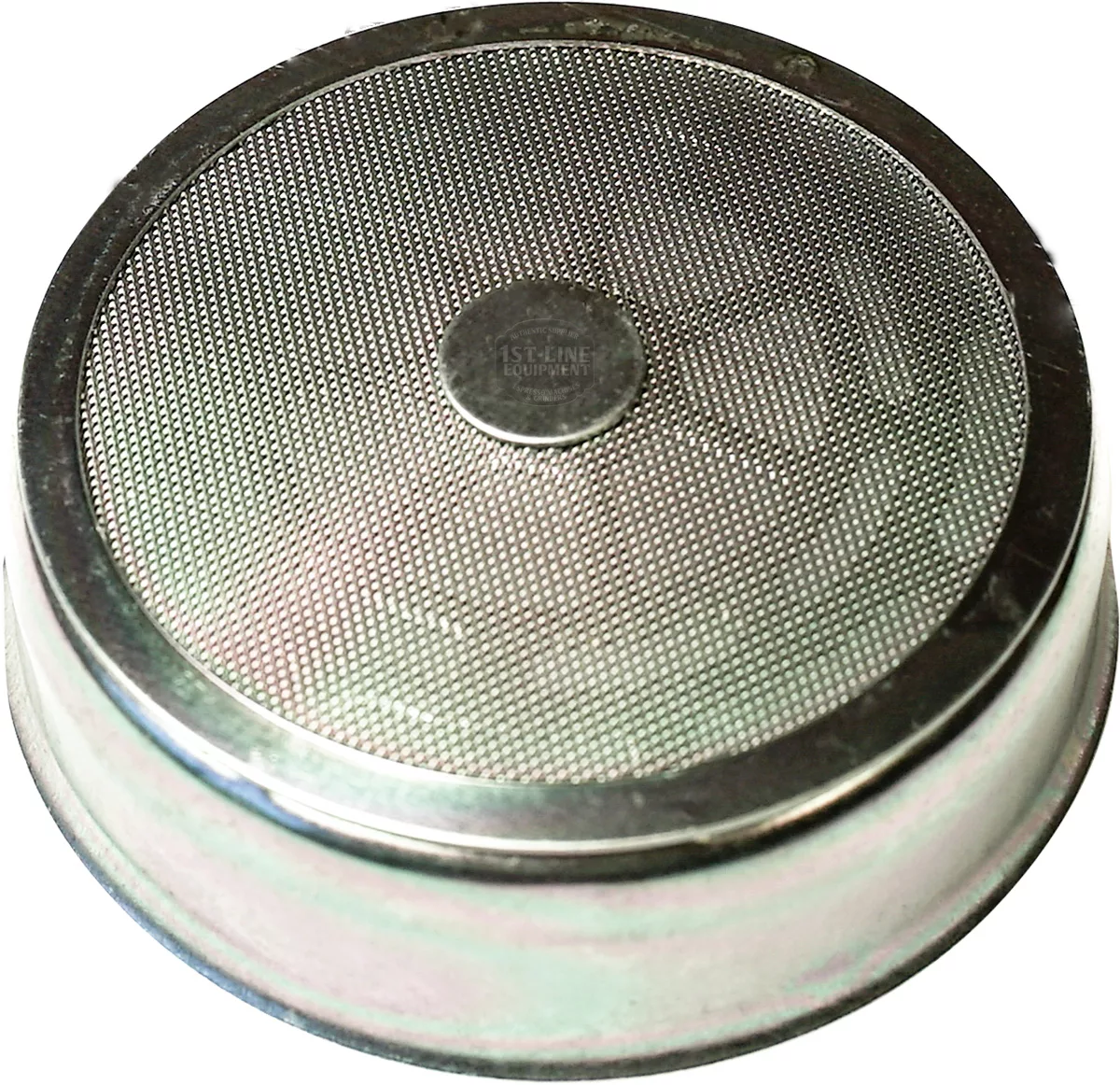 A close-up of a Faema stainless steel espresso machine filter basket with a fine mesh bottom and ridged edge, paired with the Faema NanoQuartz Convex Spokes Dispersion Screen for optimal extraction. © 2025 1st-line.com