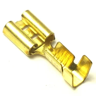 A close-up of a gold-colored V..559 MALE FAXTON TERMINAL crimp connector, commonly used for electrical wiring and connections. © 2025 1st-line.com