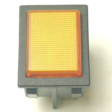 A close-up of a rectangular orange illuminated rocker switch with a textured surface in a black frame, shown next to an LB..55 220V RED WARNING LAMP, both set against a white background. © 2025 1st-line.com