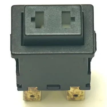 A close-up of a V.4263 19x13mm MOMENTARY PUSH-BUTTON, black and rectangular, featuring two square holes on top, two brass terminals at the bottom, and a slightly worn surface. © 2025 1st-line.com