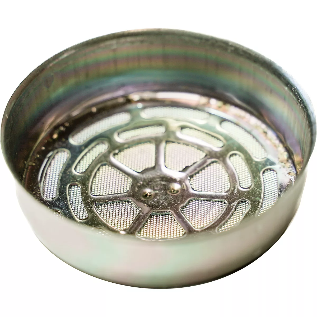 A close-up of the Faema NanoQuartz Convex Spokes Dispersion Screen, featuring a round metal design with a raised edge and grid-like center, commonly used for effective filtering or straining. © 2025 1st-line.com