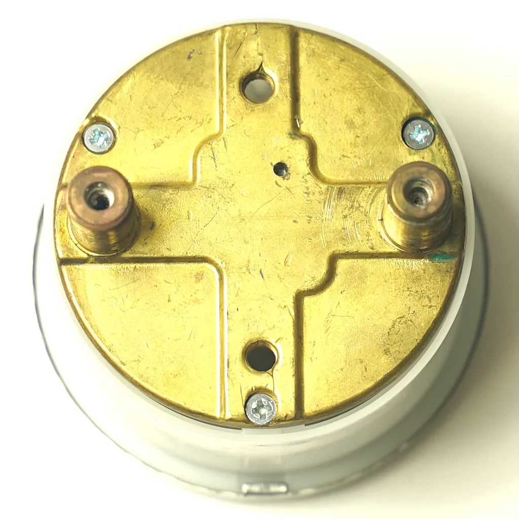 A close-up of the R..515 MILLENNIUM DOUBLE MANOMETER shows its metallic circular body with a gold-colored top, three screws, and two cylindrical connectors on a white background. © 2025 1st-line.com