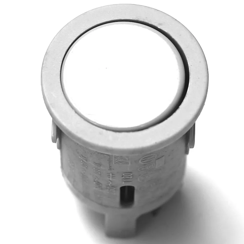 A close-up of the V.4239 PUSH SWITCH - GREY, featuring a round design with a flat white top, viewed from above on a white background. © 2025 1st-line.com
