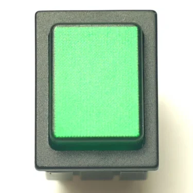 A close-up of the V.4289 BLACK PUSH SWITCH, featuring a rectangular green button in a black plastic casing, set against a white background. © 2025 1st-line.com