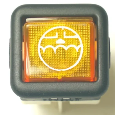 A close-up of the V.4407 MOMENTARY ROCKER SWITCH, a yellow square button with a black border and a white windshield wiper icon, used for a cars windshield washer function. © 2025 1st-line.com