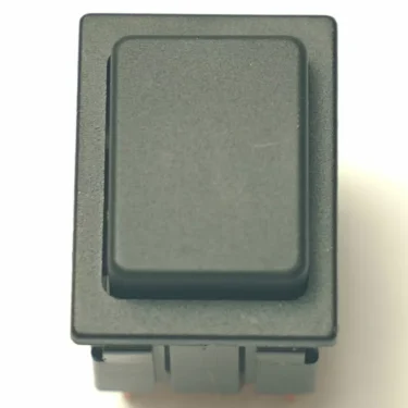 A close-up photo of the V.4291 GREEN SWITCH—a black rectangular rocker switch with a green accent—shown from above against a light background. © 2025 1st-line.com