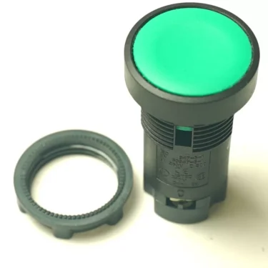 A green round industrial push button switch with a black plastic housing is shown next to its separate threaded mounting ring and an LB..55 220V RED WARNING LAMP, all placed on a white background. © 2025 1st-line.com