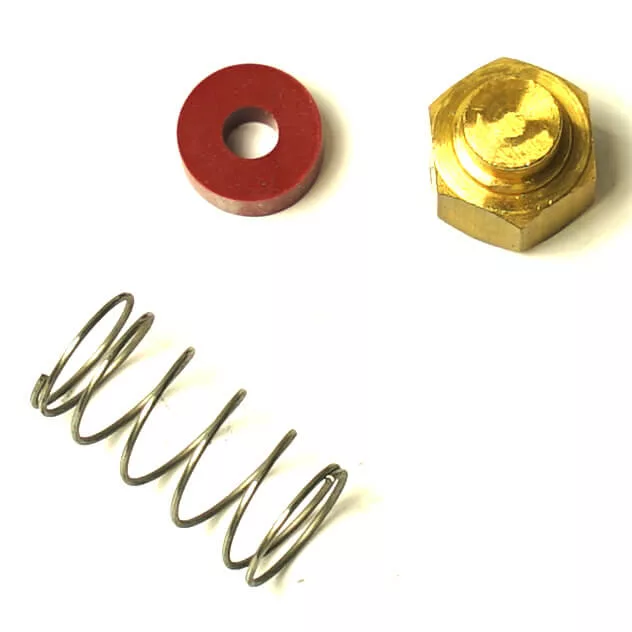 A metal spring, a hexagonal brass nut, and a red Nuova Simonelli Group Head Filter Holder Gasket 71x56x8.2mm with a center hole are arranged on a white background. © 2025 1st-line.com