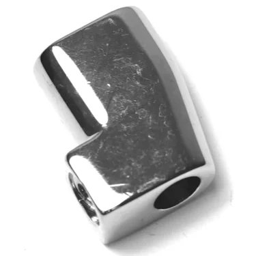 A shiny, metallic W..552 ROD BLOCKING NUT, L-shaped with rounded edges and a hole at one end, is photographed on a white background. © 2025 1st-line.com