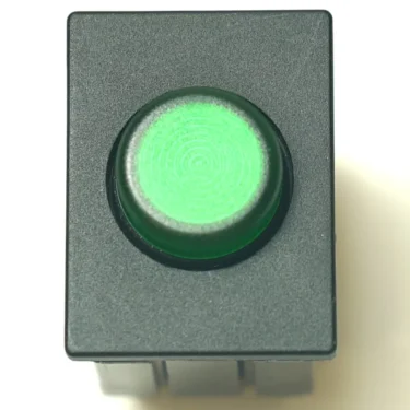 A top-down view of the Ascaso V.4276 GREEN LIGHT SWITCH, showing its rectangular black design with a circular green illuminated center, set against a white background. © 2025 1st-line.com