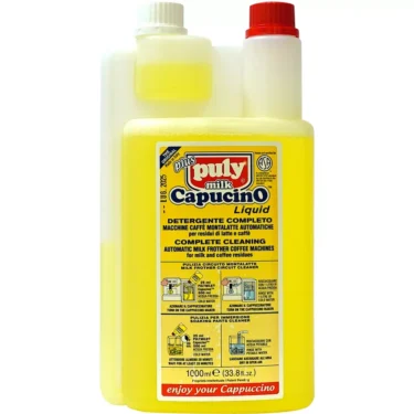 A yellow 1LT bottle of Puly Capucino Complete Detergent for automatic milk frother coffee machines, with a white measuring chamber and a multilingual label. © 2025 1st-line.com