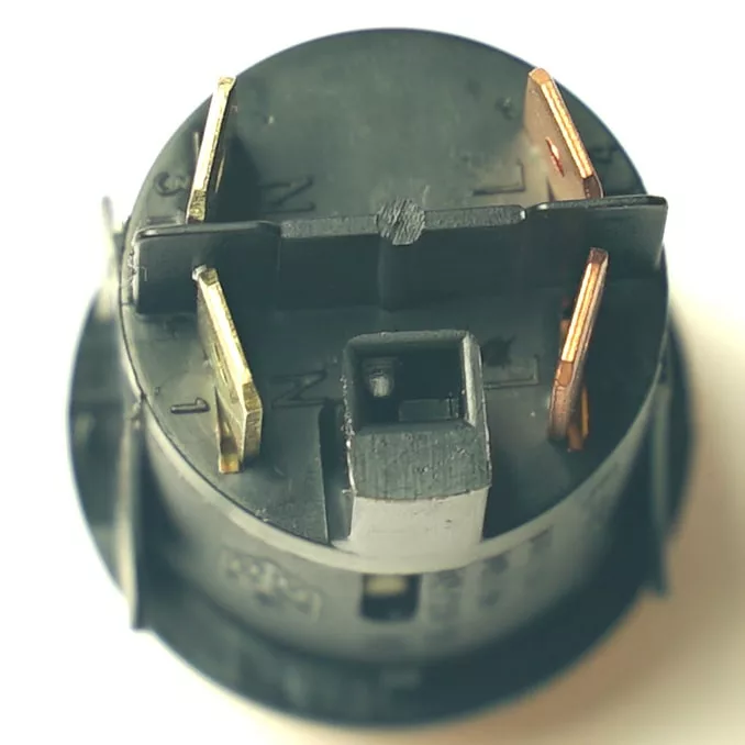 Close-up of a black relay socket with four metal prongs and labeled contacts next to a V.4331 YELLOW MOMENTARY PUSH SWITCH, photographed from above on a white background. © 2025 1st-line.com