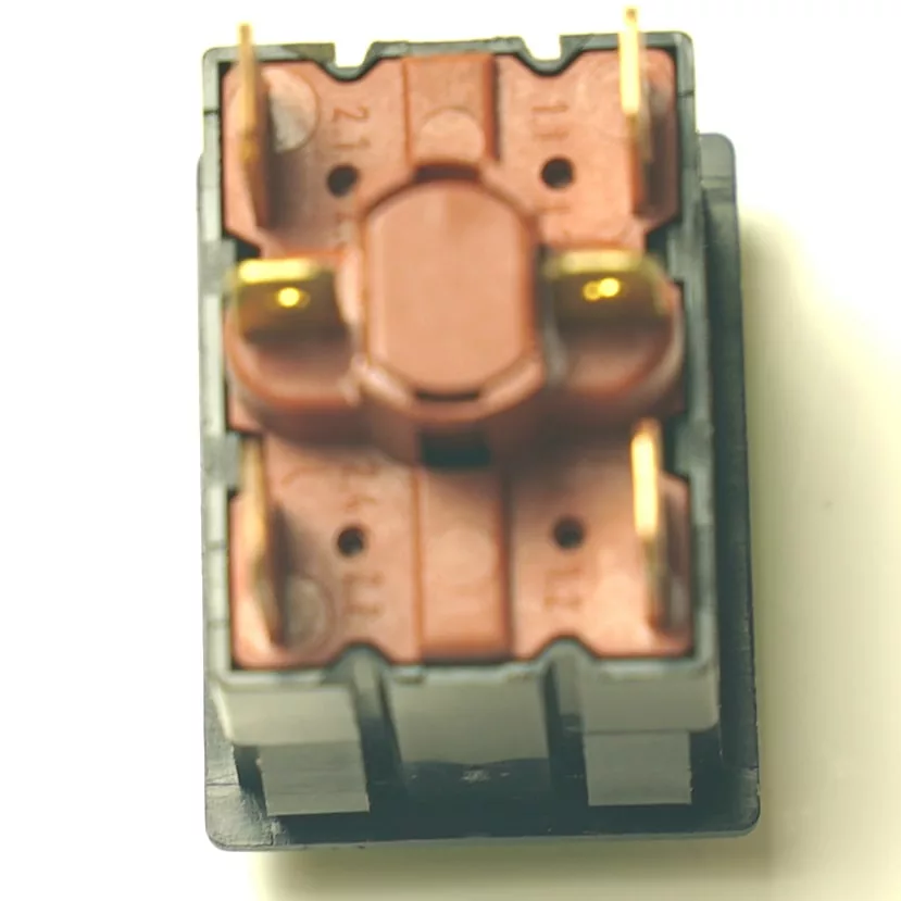 Close-up of a brown mechanical keyboard switch with four gold pins, mounted in a SAM.40 BLACK PUSH-BUTTON black plastic housing, viewed from above on a light background. © 2025 1st-line.com