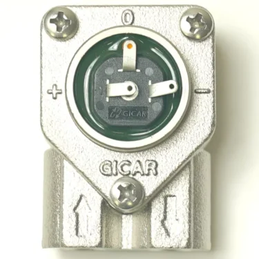 Close-up of a metallic GICAR V.1437 1/8 3 CONNECTIONS FLOWMETER with a round green and black dial, plus/minus symbols, screws at the corners, and arrows pointing downwards. © 2025 1st-line.com