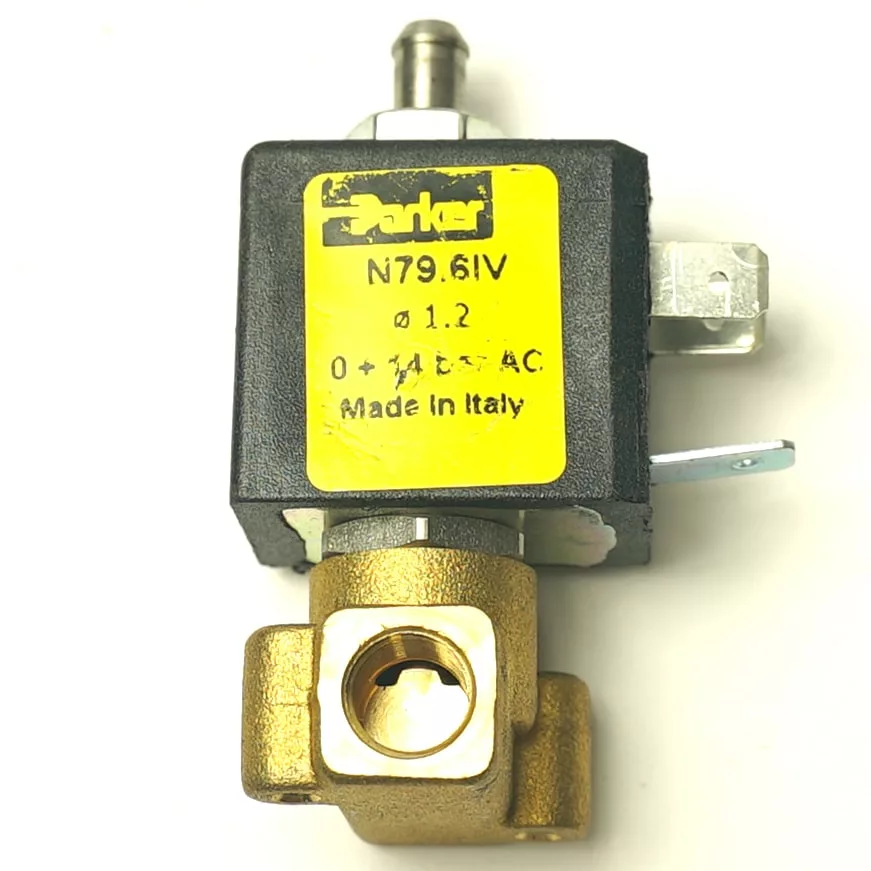 Close-up of a Parker solenoid valve with a yellow label showing model N79.61V, 1.2 mm, 0–14 bar AC, “Made in Italy,” and V.1696 600mm TOUCHPAD RIBBON WIRING attached to the black and brass housing with metal connectors. © 2025 1st-line.com
