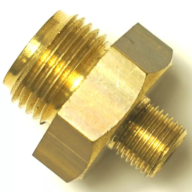 Close-up of an SM.356 GROUP FITTING brass pipe adapter featuring male threads on both ends and a hexagonal center for tightening, with a highly reflective, shiny metal surface. © 2025 1st-line.com