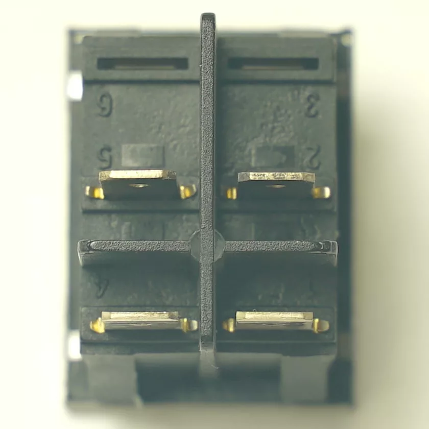 Close-up of the back of a V.4383 YELLOW ROCKER SWITCH + PILOT showing four metal connectors and numbered labels 1 to 6 on the dark plastic housing. © 2025 1st-line.com