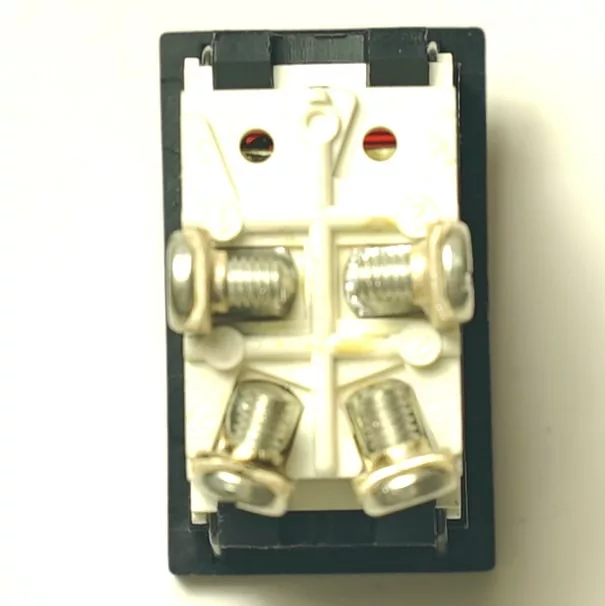 Close-up of the back of the V.4279 Yellow Light Push-Button, showing four screw terminals for wiring. The rectangular switch has a white and black plastic casing and is designed for use with a yellow light push-button. © 2025 1st-line.com