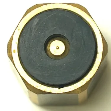 Close-up of the F.2399 COMPLETE VALVE showing its brass hexagonal connector, black circular center, and a small gold pin, resembling an RF or coaxial valve connector. © 2025 1st-line.com