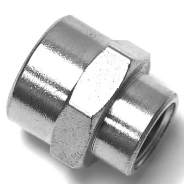 Close-up of the V.1873 1/8Fx1/4F FITTING, a shiny metal connector with a hexagonal center and cylindrical ends, designed for joining two pipes or tubes in plumbing or industrial setups. © 2025 1st-line.com