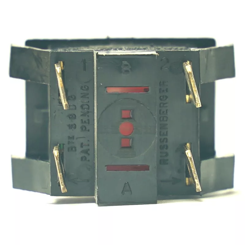 Close-up of the V.4277 GREEN LIGHT PUSH-BUTTON switch: black plastic body, six metal prongs, letter/number labels, red markings, and a green light push-button visible through front windows. © 2025 1st-line.com