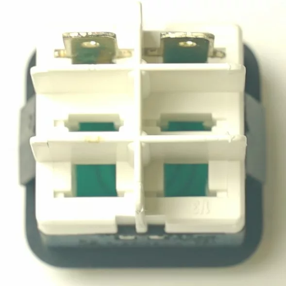 Close-up of the V.4423 DOUBLE PILOT, a white rectangular component with four separate sections and two metal prongs on top, viewed from above against a light background. © 2025 1st-line.com