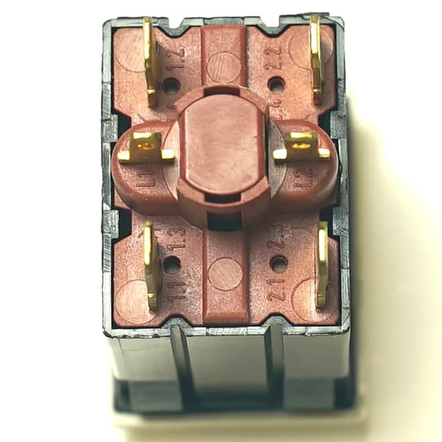 Close-up view of the underside of the V.4281 LAMP + ORANGE SWITCH showing its brown plastic housing and visible metal contacts. © 2025 1st-line.com