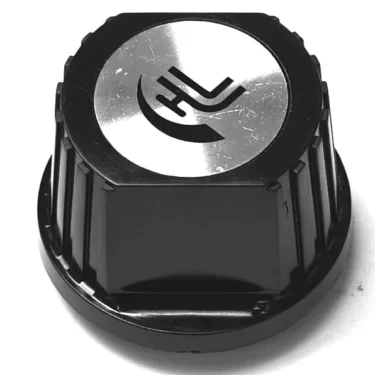 The Astoria/Wega WATER HANDLE is a black plastic knob with a silver metallic top featuring a curved and straight line logo, ridged for grip. Shown against a white background. © 2025 1st-line.com