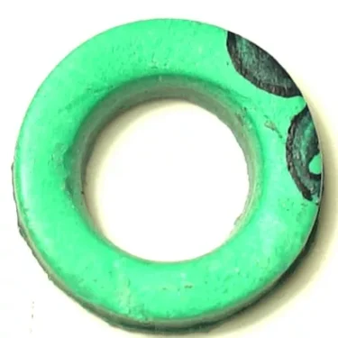 The CA.208 ALIMENTARY GASKET 15x7x2 mm is a green, circular gasket with a smooth surface and a small black mark or drawing on the upper right side. © 2025 1st-line.com