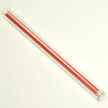 The CA..40 12X130 LEVEL CRYSTAL, a clear plastic tube measuring 12x130 mm, holds one red pencil shown diagonally on a white background. © 2025 1st-line.com