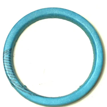 The F..254 ALIMENTARY GASKET 26x22x2 mm, blue and circular with a smooth finish and minor dark marks on one side, is displayed against a white background. © 2025 1st-line.com