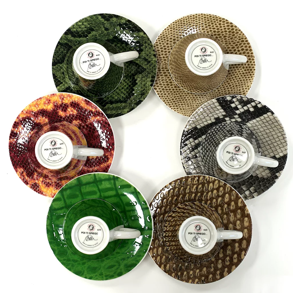 The Francis!Francis! Reptilia Espresso Cups - Set of Six includes cups with matching saucers in green, brown, red, and gray reptile or snake skin patterns. Each white cup features the distinctive Francis!Francis! logo. © 2025 1st-line.com