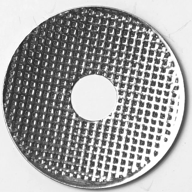 The R.1033 STAINLESS STEEL SHOWER is a round, metallic disc featuring a textured grid surface and central hole, photographed against a plain white background. © 2025 1st-line.com
