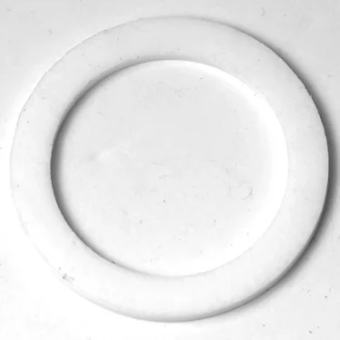 The R..462 PTFE Heating Element Gasket 65x46x1.5mm, with a flat washer-like profile and white finish, is displayed on a plain white background. © 2025 1st-line.com