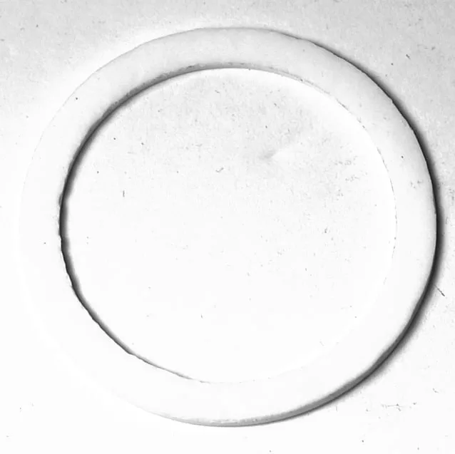 The S..221 PTFE RESISTANCE GASKET 68x55x3mm appears as a white circular ring with a thin border on a plain background, showcasing its minimal design and subtle texture with soft shadows. © 2025 1st-line.com